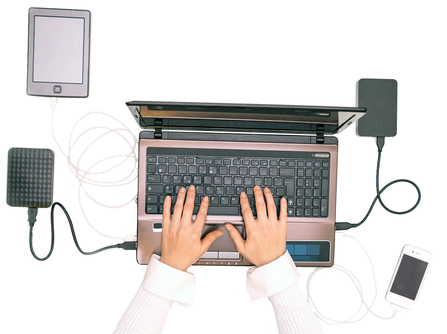 Hands typing on a laptop connected to multiple external devices, representing IT support and hardware management.